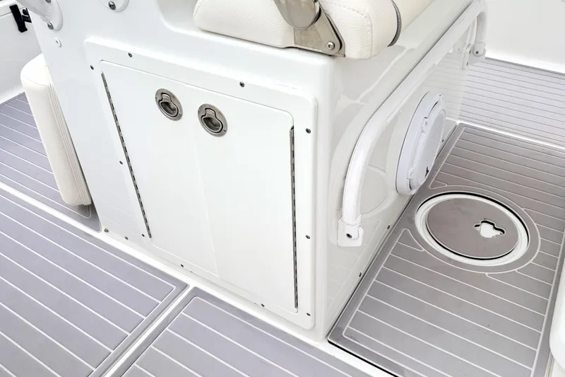 Slide: The Image of 2023 Sea Hunt Escape 28 boat interior with storage compartment and non-slip flooring. - 19