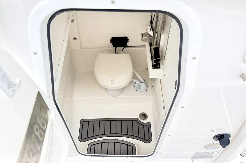 Slide: The Image of 2023 Sea Hunt Escape 28 boat interior with compact marine toilet. - 22
