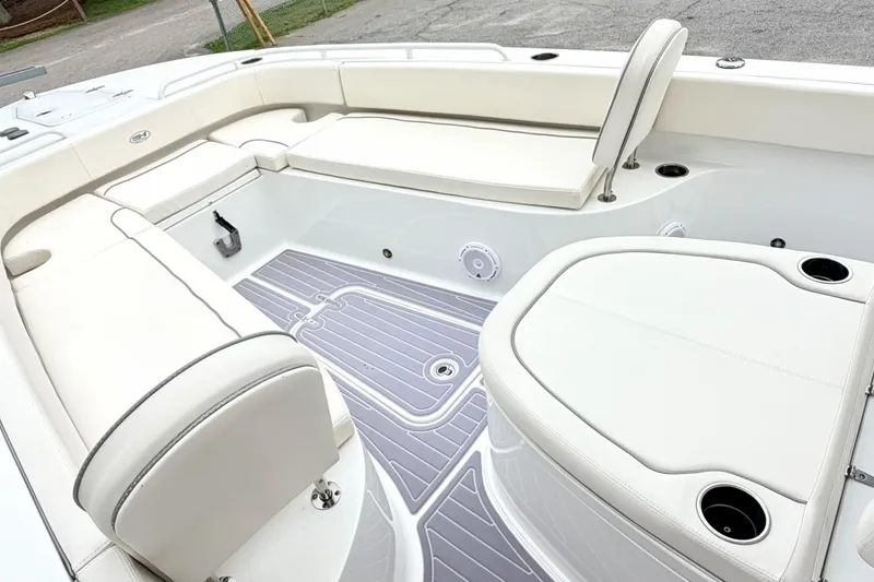 Slide: The Image of 2023 Sea Hunt Escape 28 boat interior with white seating and modern design. - 24