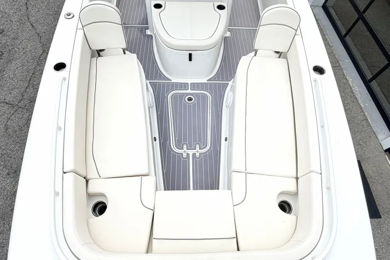 Slide: The Image of 2023 Sea Hunt Escape 28 boat interior with white seating and gray flooring. - 25