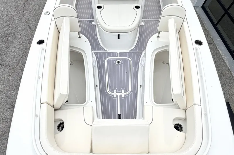 Slide: The Image of 2023 Sea Hunt Escape 28 boat interior with cushioned seating and storage compartments. - 26