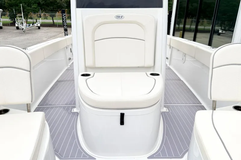Slide: The Image of 2023 Sea Hunt Escape 28 boat interior with white seating and sleek design. - 27