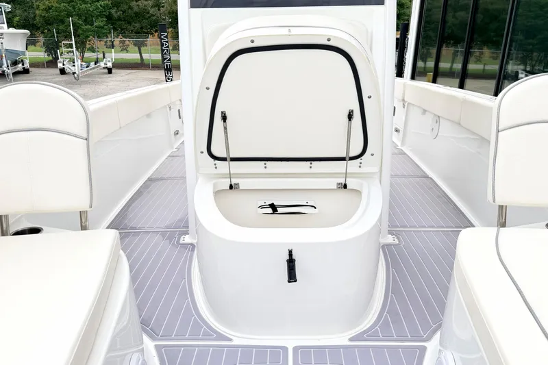 Slide: The Image of 2023 Sea Hunt Escape 28 boat interior with open storage compartment and seating. - 28