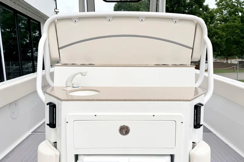 Slide: The Image of 2023 Sea Hunt Escape 28 boat interior with sink and storage area. - 6