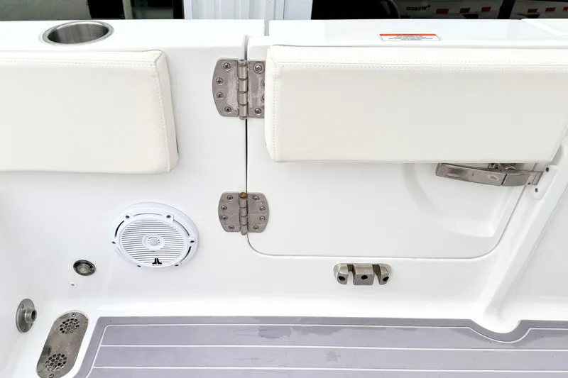 Slide: The Image of 2023 Sea Hunt Escape 28 boat interior with speaker and cushioned seating. - 8
