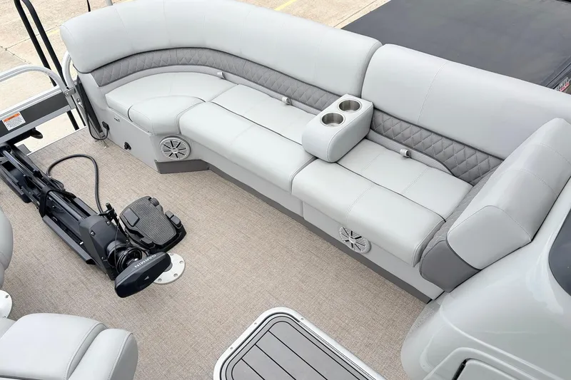 Slide: The Image of 2021 Ranger 223FC boat interior with gray seating, cup holders, and trolling motor. - 14