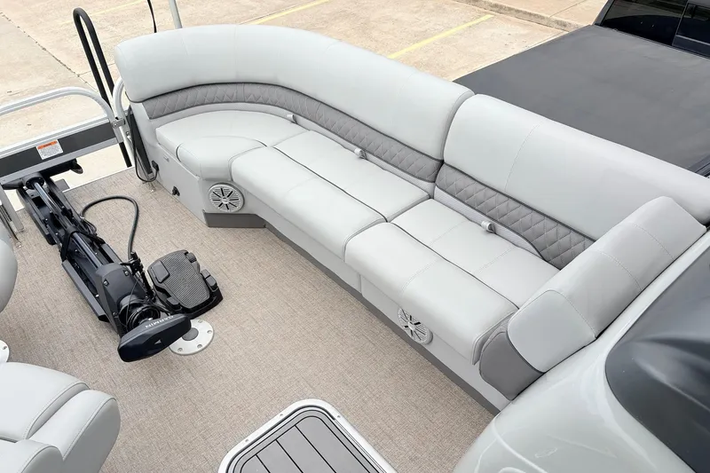 Slide: The Image of 2021 Ranger 223FC boat interior with gray seating and trolling motor. - 15