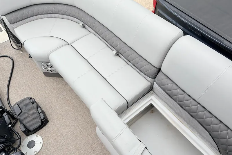 Slide: The Image of Luxurious seating on 2021 Ranger 223FC boat with storage compartment and speaker. - 16