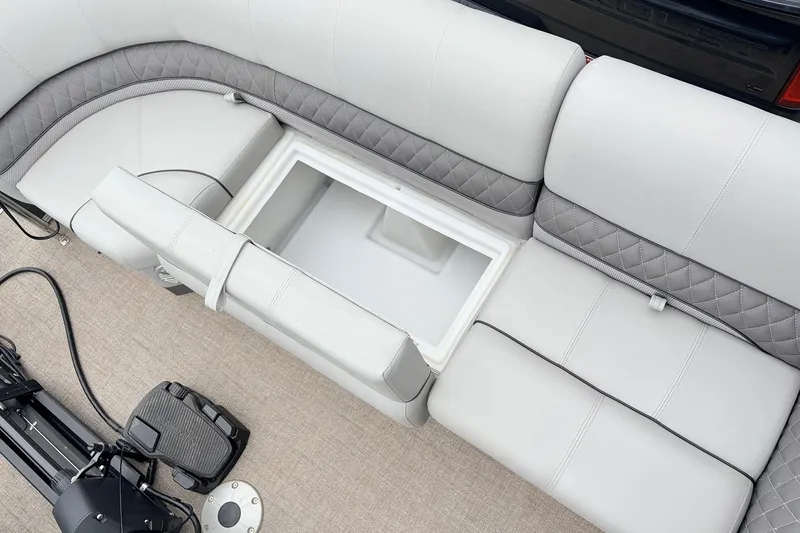 Slide: The Image of 2021 Ranger 223FC boat interior with open storage compartment and cushioned seating. - 17