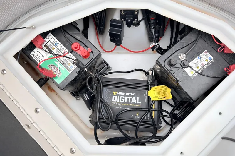 Slide: The Image of 2021 Ranger 223FC boat battery compartment with Minn Kota digital charger. - 19