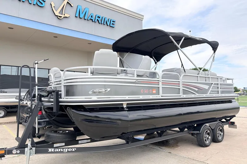 Slide: The Image of 2021 Ranger 223FC pontoon boat on trailer outside marine dealership. - 2