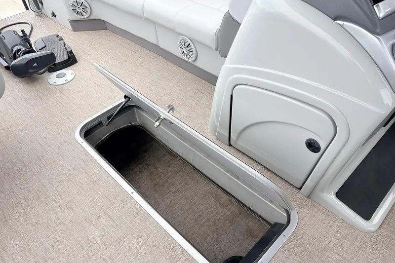 Slide: The Image of 2021 Ranger 223FC boat interior with open storage compartment and seating area. - 21