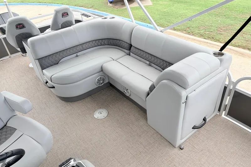 Slide: The Image of Luxurious seating on 2021 Ranger 223FC boat with gray upholstery and cup holders. - 23