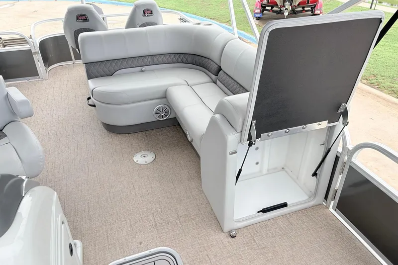 Slide: The Image of 2021 Ranger 223FC boat interior with gray seating and storage compartment open. - 24