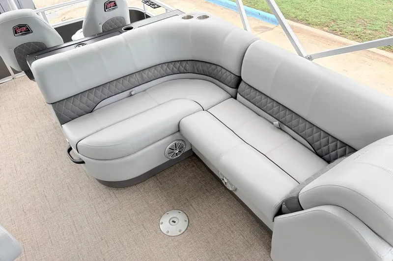 Slide: The Image of 2021 Ranger 223FC boat interior with gray cushioned seating and diamond-patterned accents. - 25