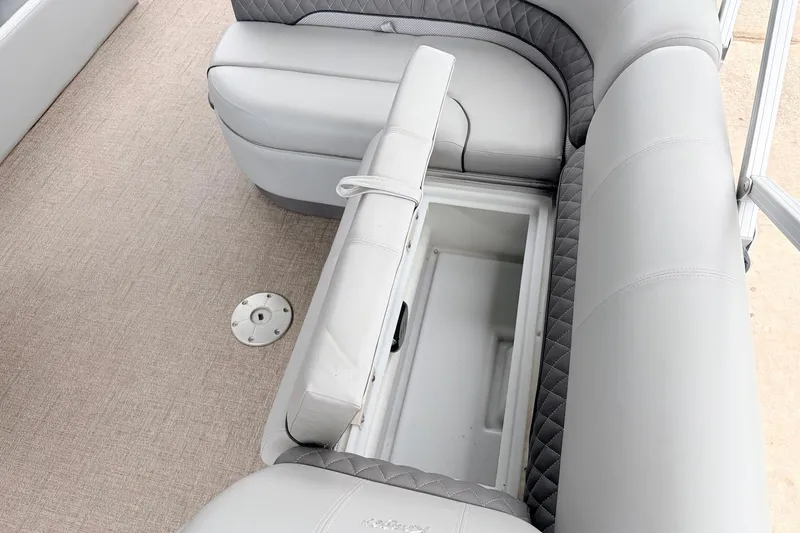 Slide: The Image of 2021 Ranger 223FC boat seat with open storage compartment, beige flooring. - 26