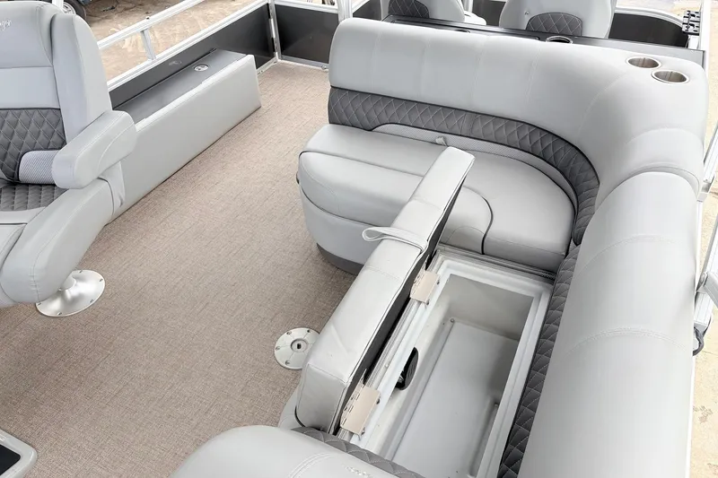 Slide: The Image of 2021 Ranger 223FC boat interior with gray seating and storage compartment open. - 27