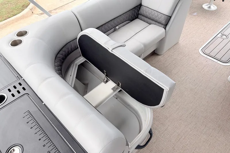 Slide: The Image of 2021 Ranger 223FC boat interior with gray seating and storage compartment open. - 28