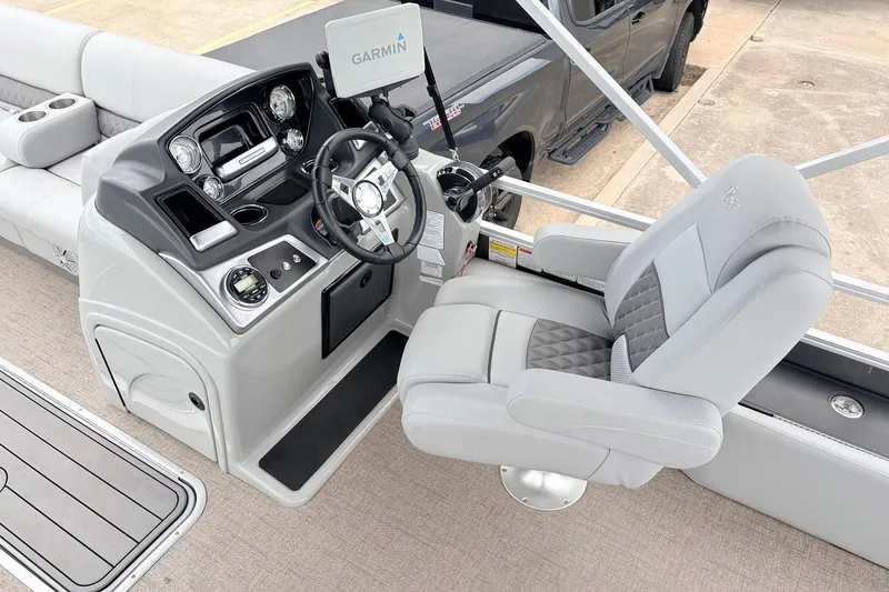 Slide: The Image of Captain's seat and helm of 2021 Ranger 223FC boat with Garmin navigation system. - 29