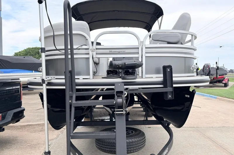 Slide: The Image of 2021 Ranger 223FC pontoon boat on trailer, rear view with canopy and seating. - 3