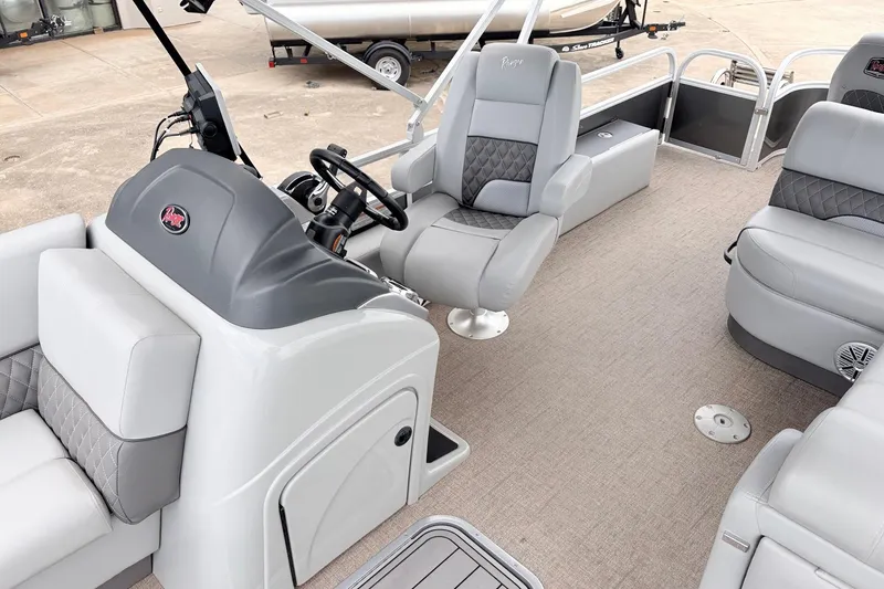 Slide: The Image of 2021 Ranger 223FC boat interior with gray seating and steering console. - 30