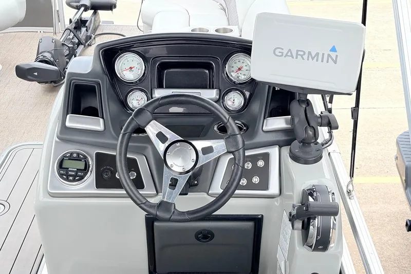 Slide: The Image of 2021 Ranger 223FC boat dashboard with Garmin navigation system and steering wheel. - 32