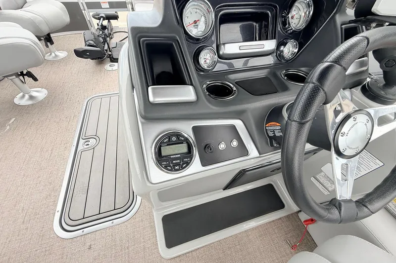 Slide: The Image of 2021 Ranger 223FC boat dashboard with steering wheel, gauges, and controls. - 33
