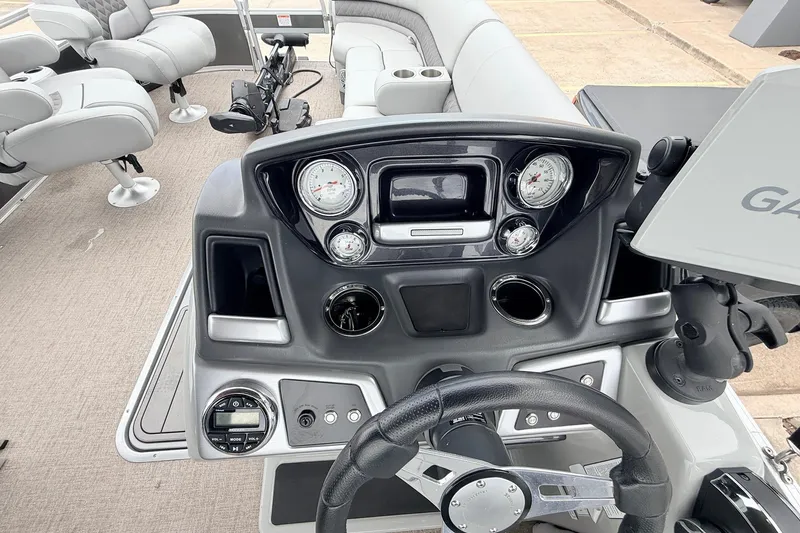 Slide: The Image of 2021 Ranger 223FC boat dashboard with gauges, steering wheel, and seating. - 34