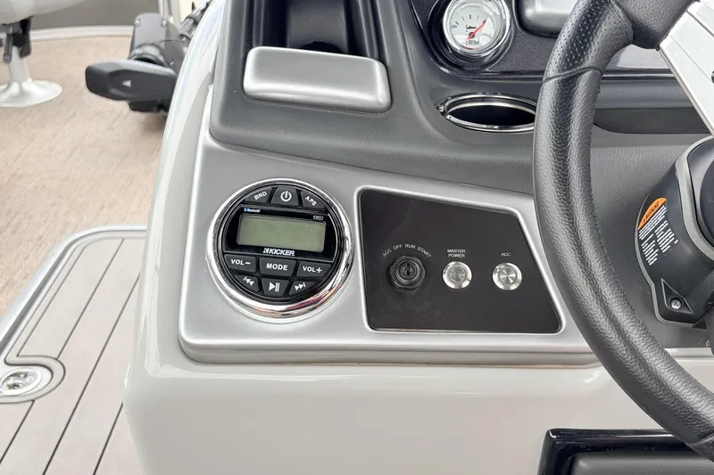 Slide: The Image of Control panel of 2021 Ranger 223FC boat featuring audio system and steering wheel. - 36
