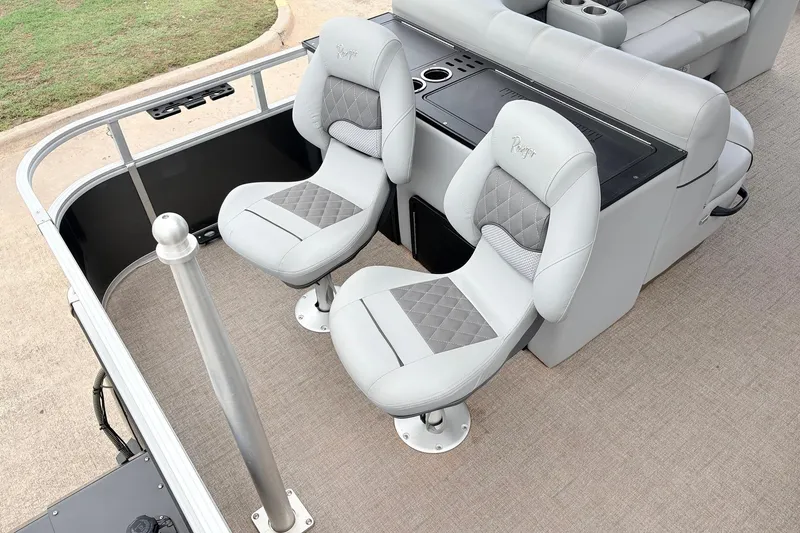 Slide: The Image of 2021 Ranger 223FC boat interior with two cushioned seats and console. - 38
