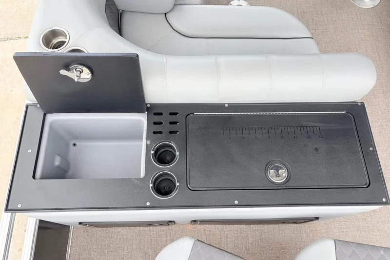Slide: The Image of 2021 Ranger 223FC boat console with sink, cup holders, and measuring board. - 41