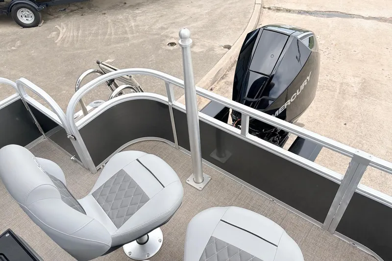 Slide: The Image of 2021 Ranger 223FC boat with Mercury engine and gray seating on a concrete surface. - 43
