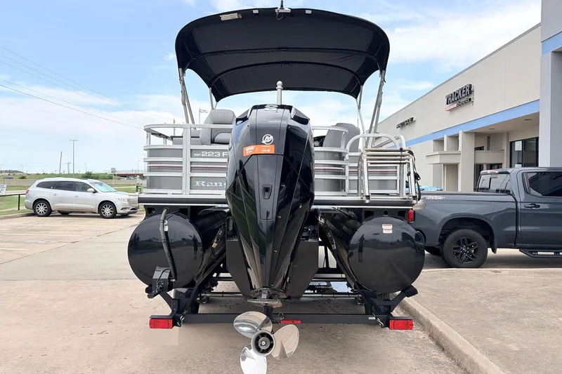 Slide: The Image of 2021 Ranger 223FC pontoon boat with outboard motor, parked at dealership. - 7