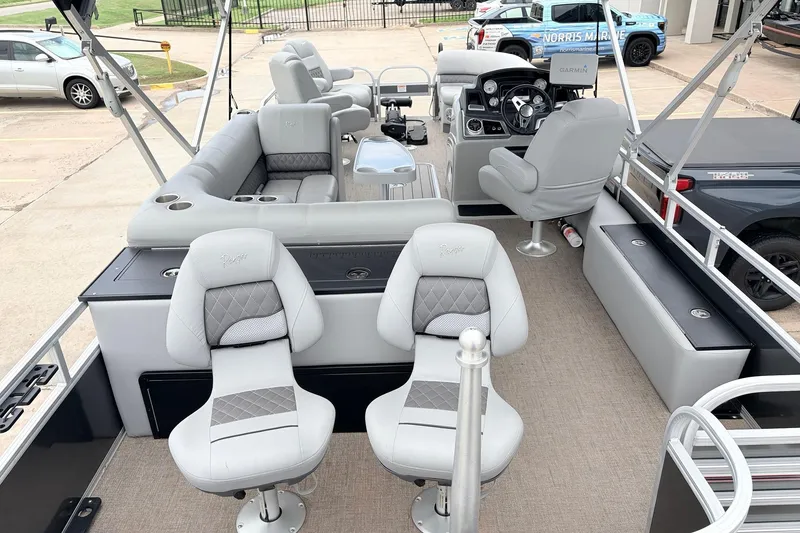Slide: The Image of 2021 Ranger 223FC boat interior with plush seating and modern dashboard. - 9