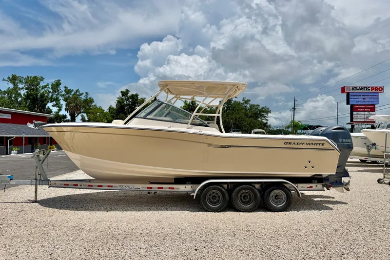 The Image of 2015 Grady-White Freedom 275 boat on trailer under cloudy sky. - 0