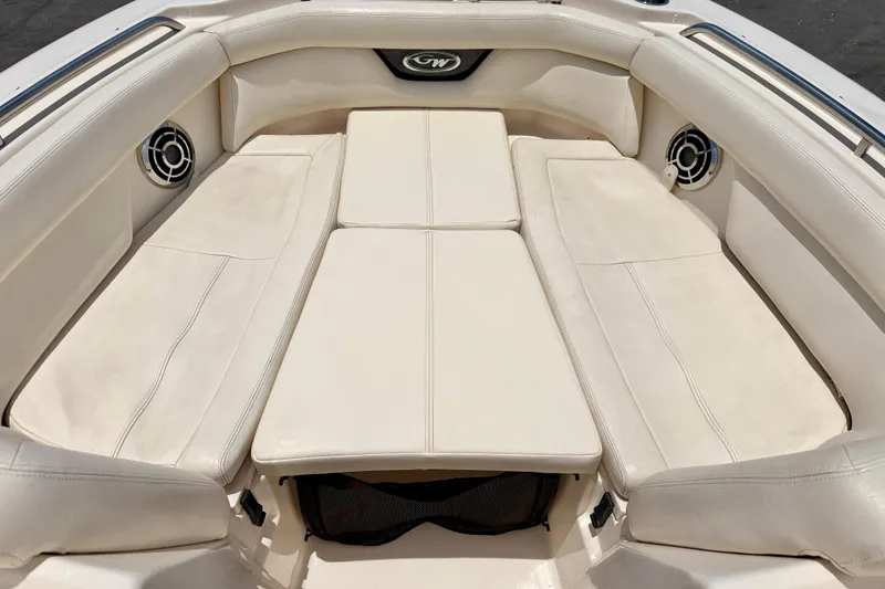 Slide: The Image of 2015 Grady-White Freedom 275 boat interior with cushioned seating and speakers. - 10