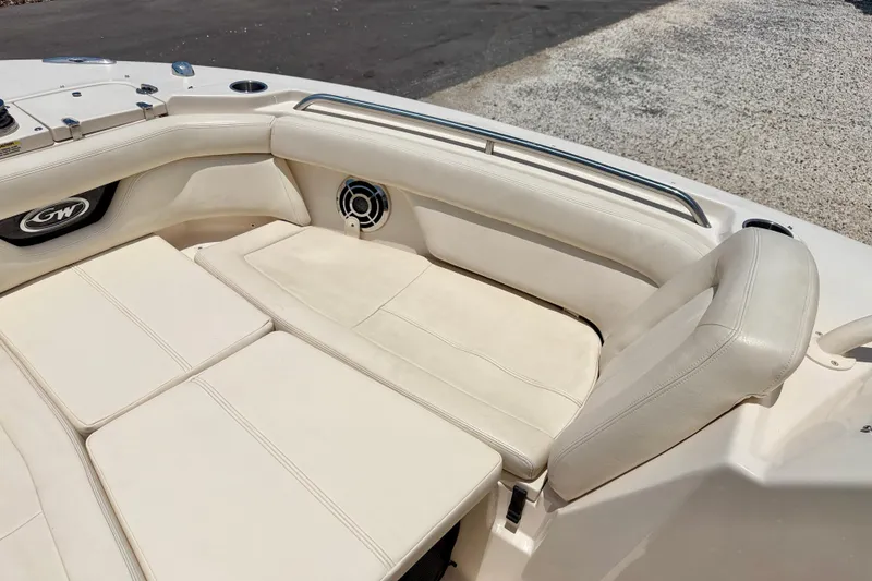 Slide: The Image of 2015 Grady-White Freedom 275 boat interior with cushioned seating and speaker. - 11