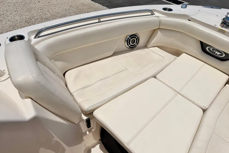 Slide: The Image of 2015 Grady-White Freedom 275 boat interior with white cushioned seating and speaker. - 12