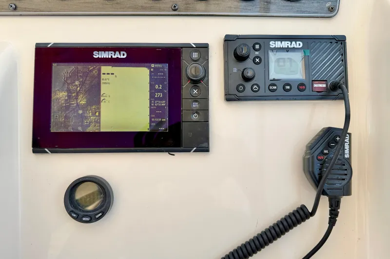 Slide: The Image of Simrad marine electronics on a 2015 Grady-White Freedom 275 boat dashboard. - 16