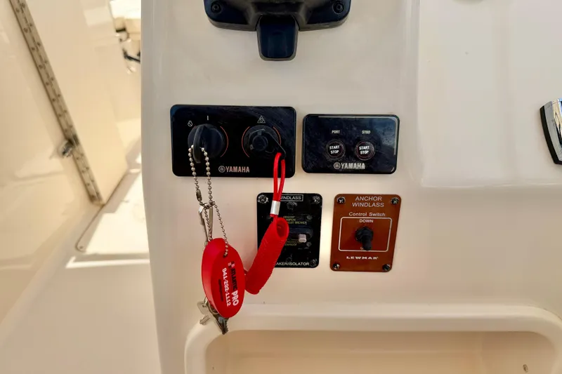 Slide: The Image of Control panel of a 2015 Grady-White Freedom 275 boat with Yamaha switches. - 17