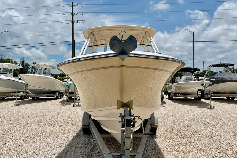 Slide: The Image of 2015 Grady-White Freedom 275 boat on trailer under blue sky. - 2