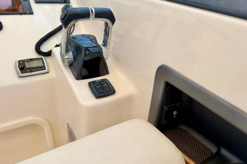 Slide: The Image of 2015 Grady-White Freedom 275 boat controls and dashboard detail. - 21