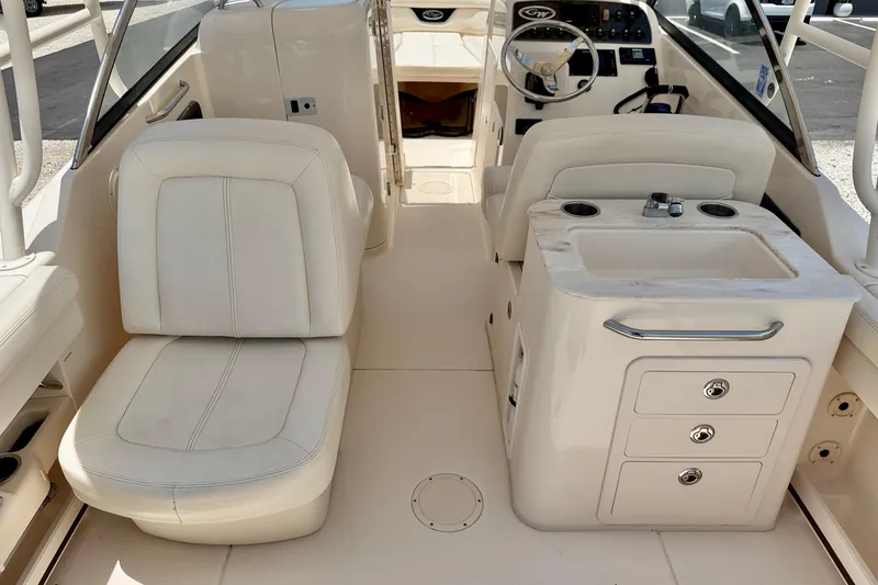 Slide: The Image of 2015 Grady-White Freedom 275 boat interior with seating and helm station. - 25