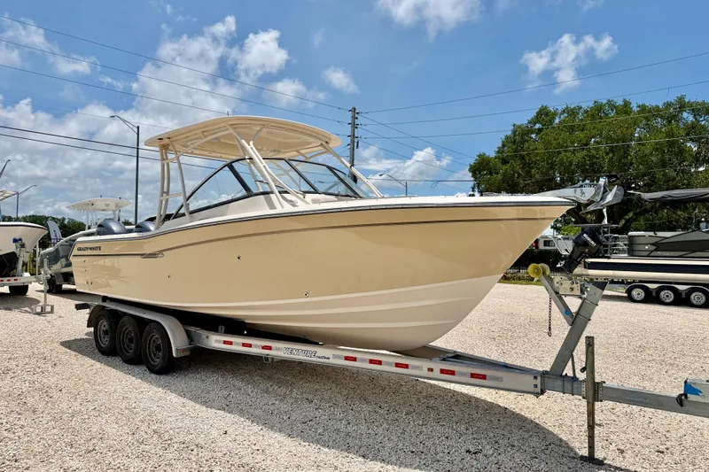 Slide: The Image of 2015 Grady-White Freedom 275 boat on trailer under blue sky. - 3