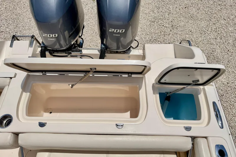 Slide: The Image of 2015 Grady-White Freedom 275 boat with dual Yamaha 200 engines and open storage compartments. - 30