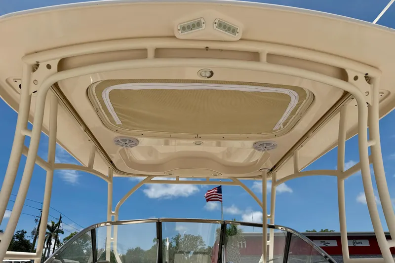 Slide: The Image of 2015 Grady-White Freedom 275 boat canopy with American flag in background. - 36