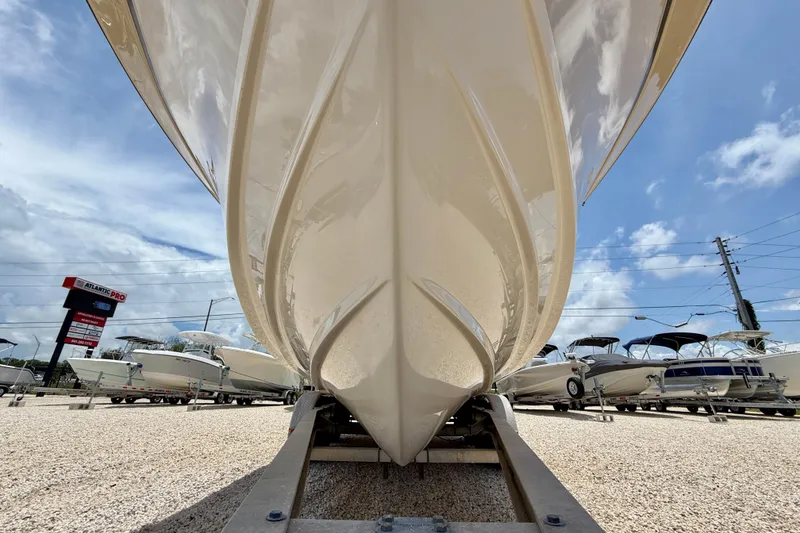 Slide: The Image of 2015 Grady-White Freedom 275 boat on trailer, under clear blue sky. - 37