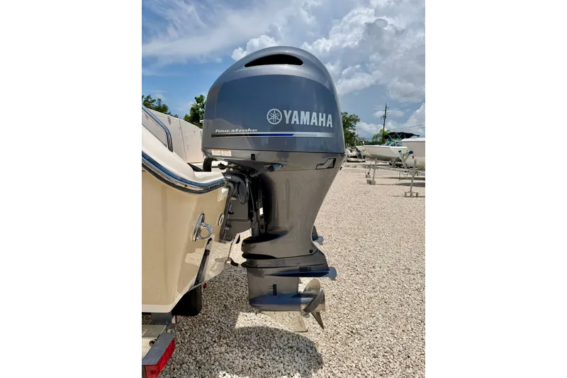 Slide: The Image of 2015 Grady-White Freedom 275 with Yamaha outboard motor in a gravel lot. - 38