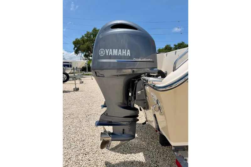 Slide: The Image of Yamaha outboard motor on 2015 Grady-White Freedom 275 boat, parked on gravel. - 39