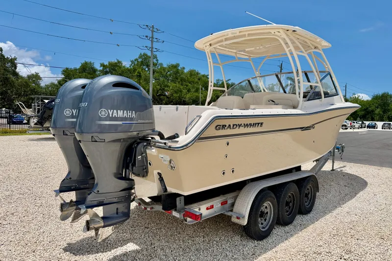 Slide: The Image of 2015 Grady-White Freedom 275 boat with dual Yamaha engines on a trailer. - 5